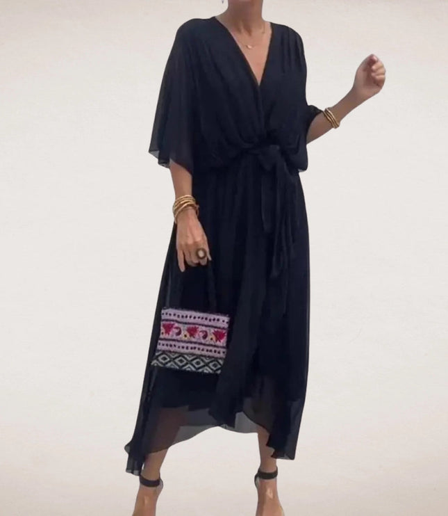 Black midi wrap dress with V neck, sheer flowing sleeves, and relaxed summer silhouette