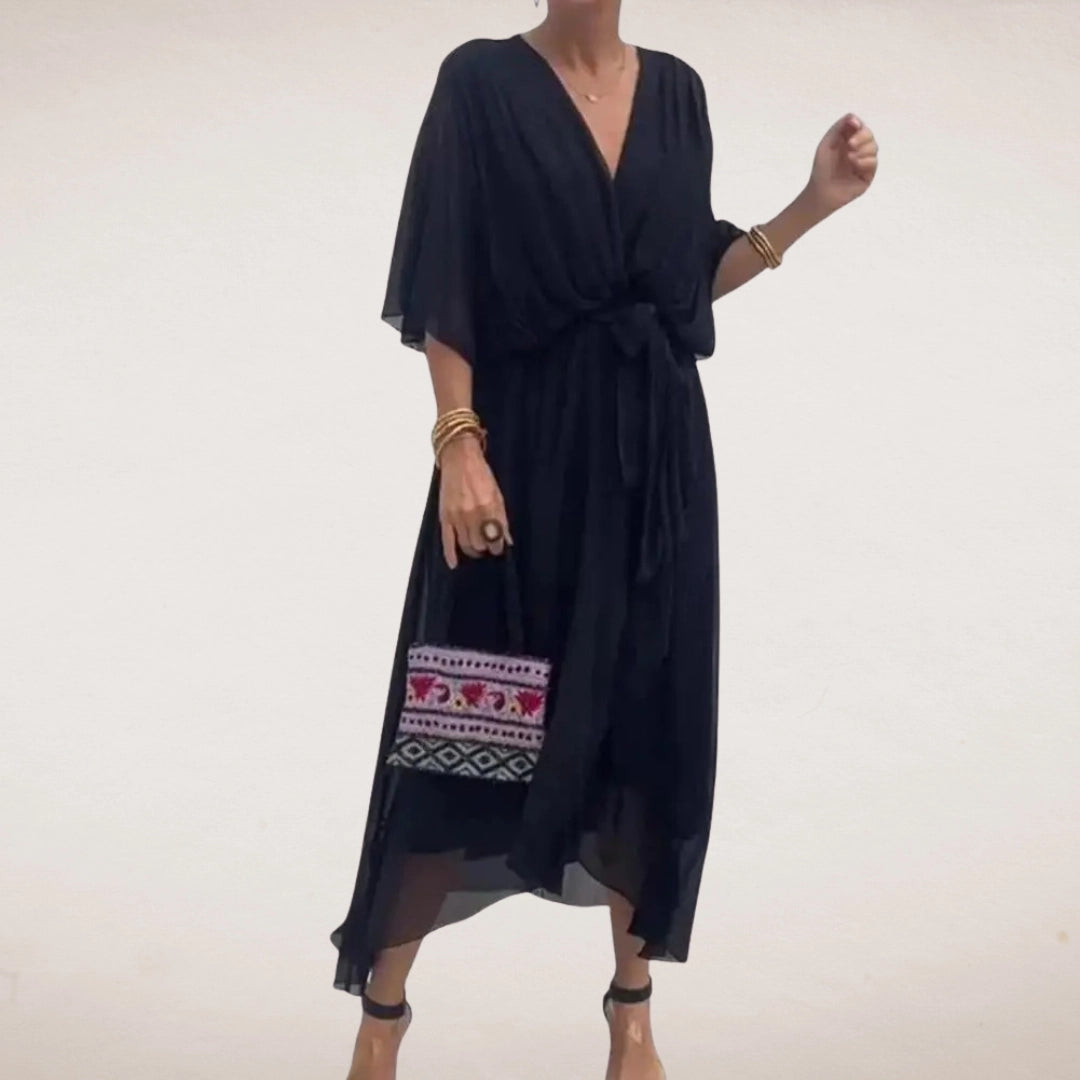 Black midi wrap dress with V neck, sheer flowing sleeves, and relaxed summer silhouette