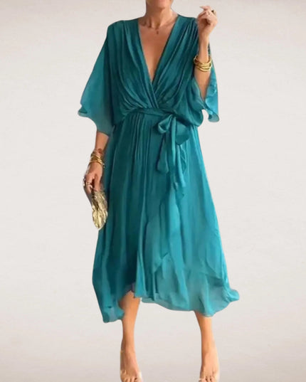 Teal midi wrap dress with deep V neck, tied waist, and soft flutter sleeves
