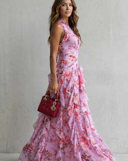 Side view of pink floral halter maxi dress showing fitted bodice and flowing skirt