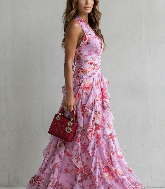 Side view of pink floral halter maxi dress showing fitted bodice and flowing skirt