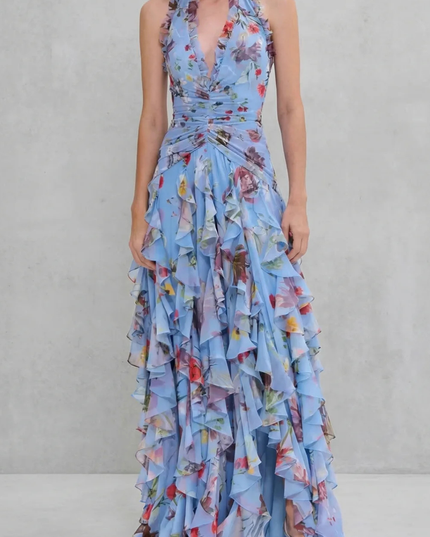 Blue floral halter maxi dress with deep V neckline and cascading ruffle layers