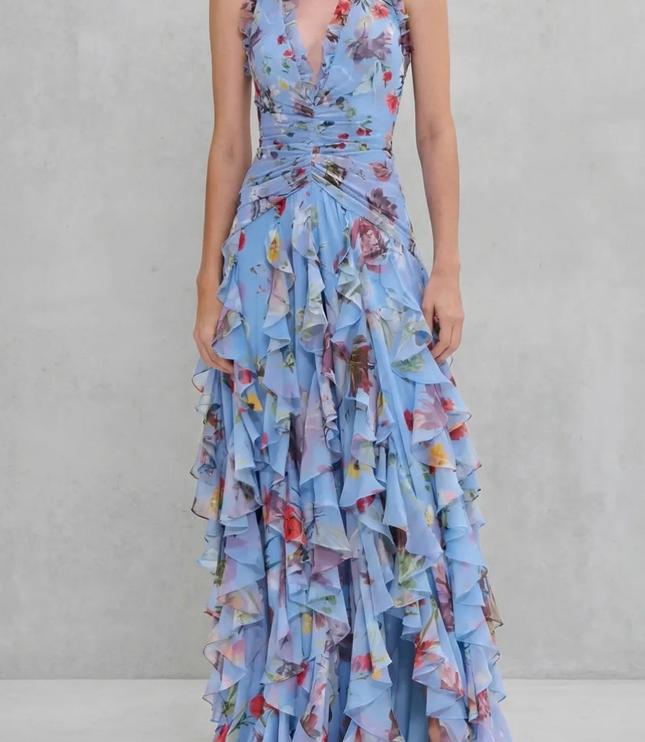 Blue floral halter maxi dress with deep V neckline and cascading ruffle layers