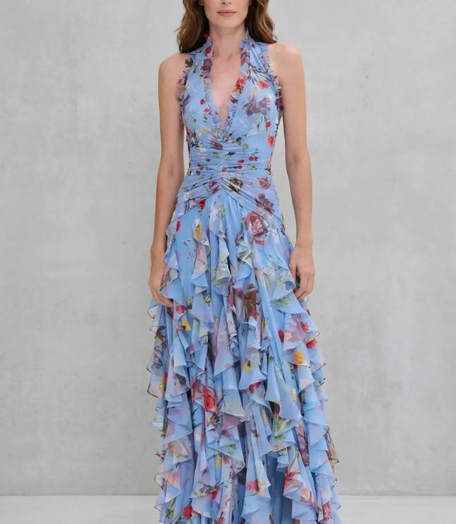 Front view of blue floral halter maxi dress with ruched waist and slit skirt