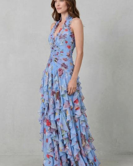 Side view of blue floral halter maxi dress with layered ruffles and floor-length hem