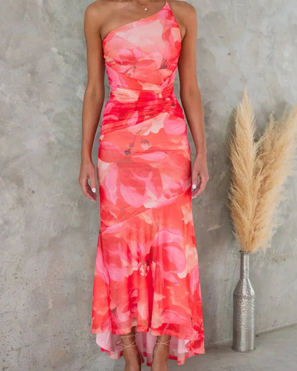 Coral pink floral midi dress with one shoulder neckline and flowing high-low skirt