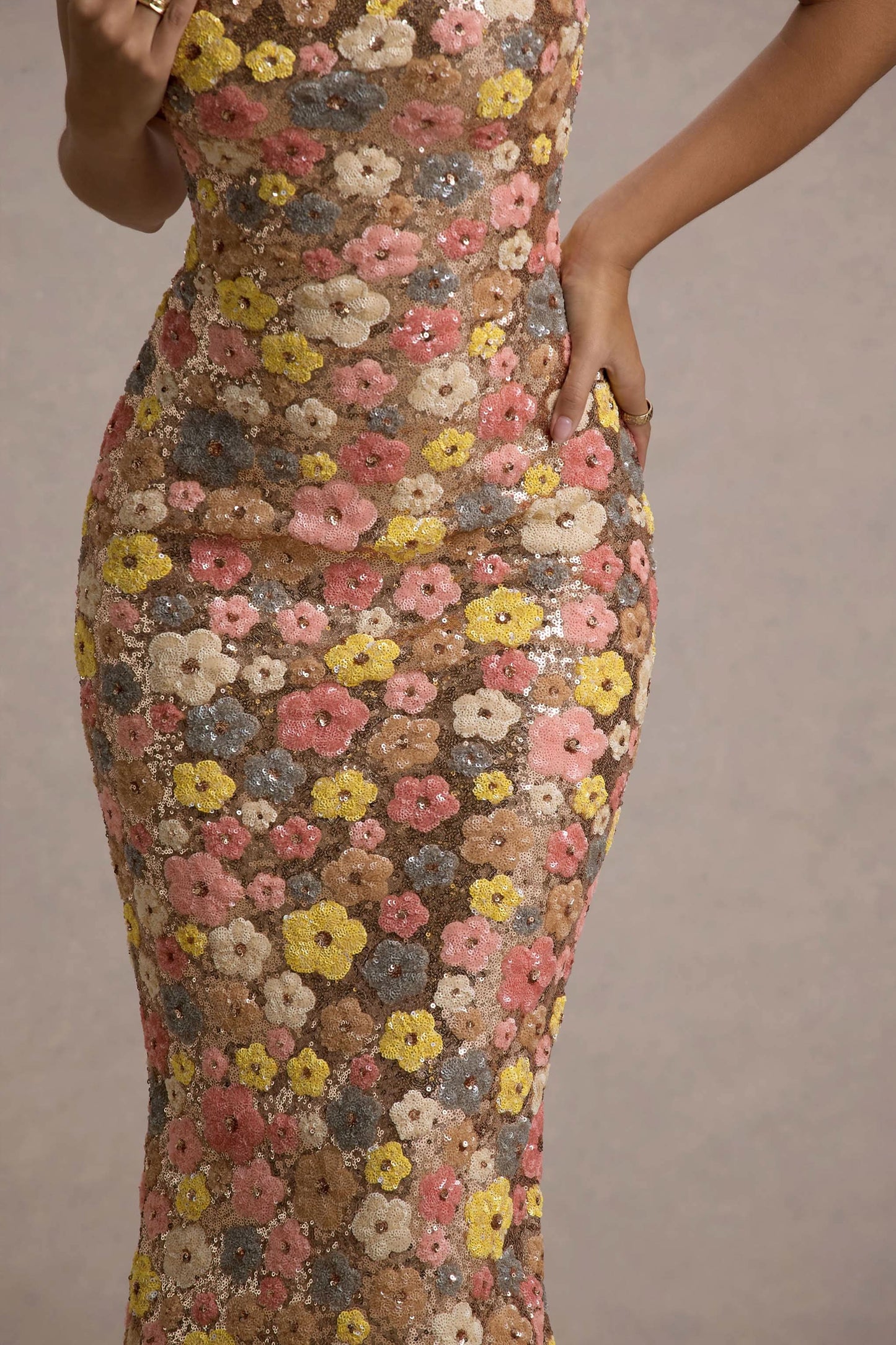 Close-up of women’s floral sequin maxi dress showing multicolor flower sequins and fitted bodice