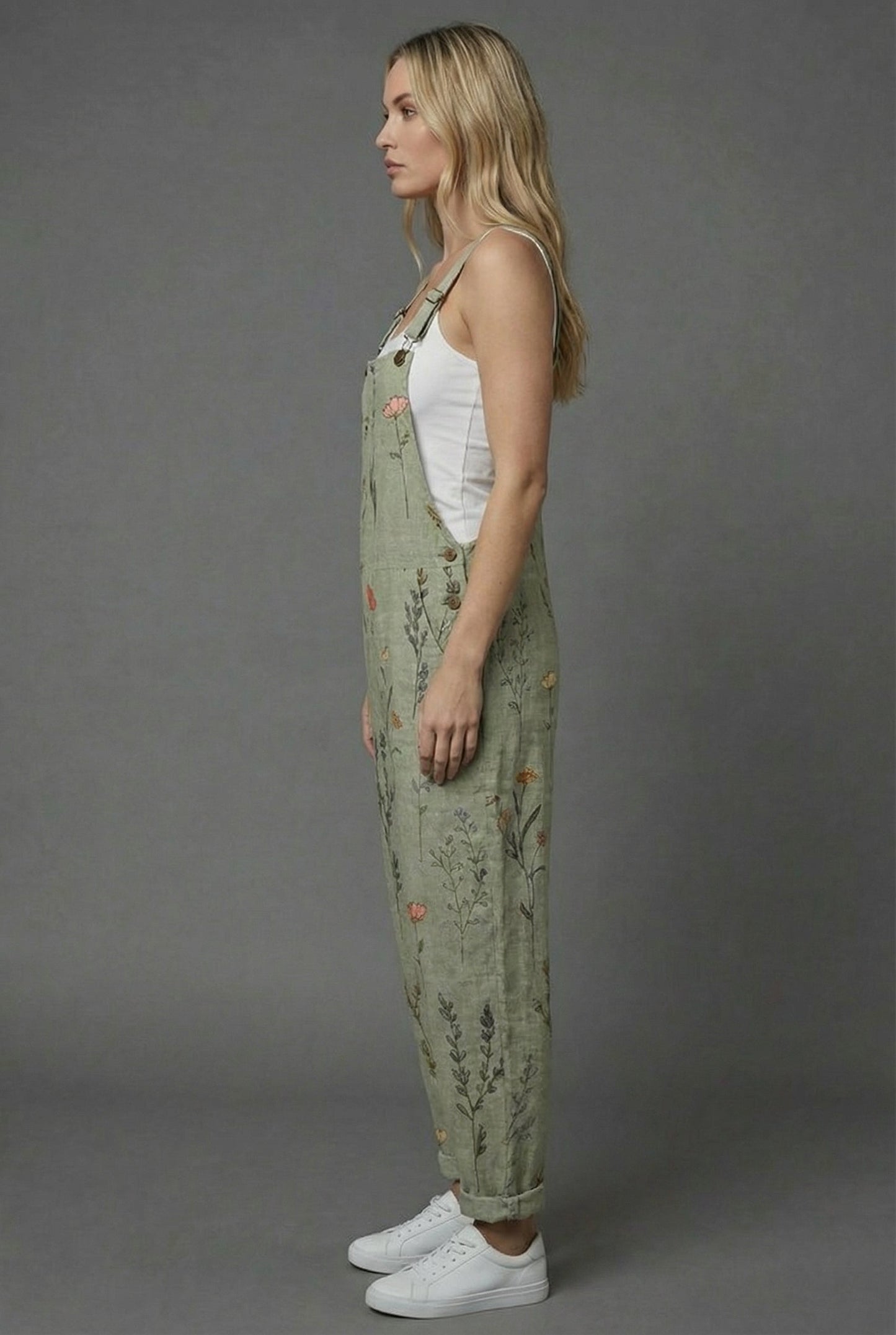 Side view of botanical print romper with relaxed fit, wide legs, and cuffed hems