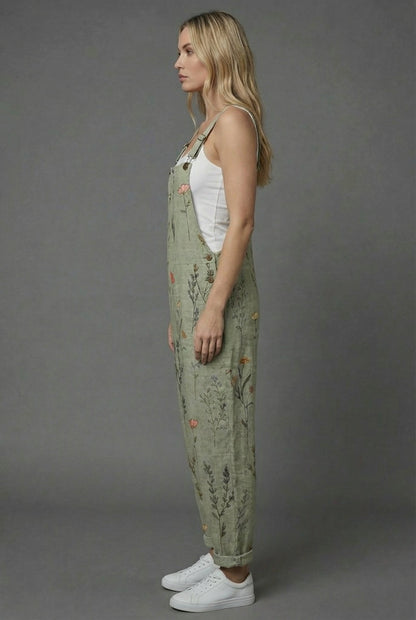 Side view of botanical print romper with relaxed fit, wide legs, and cuffed hems
