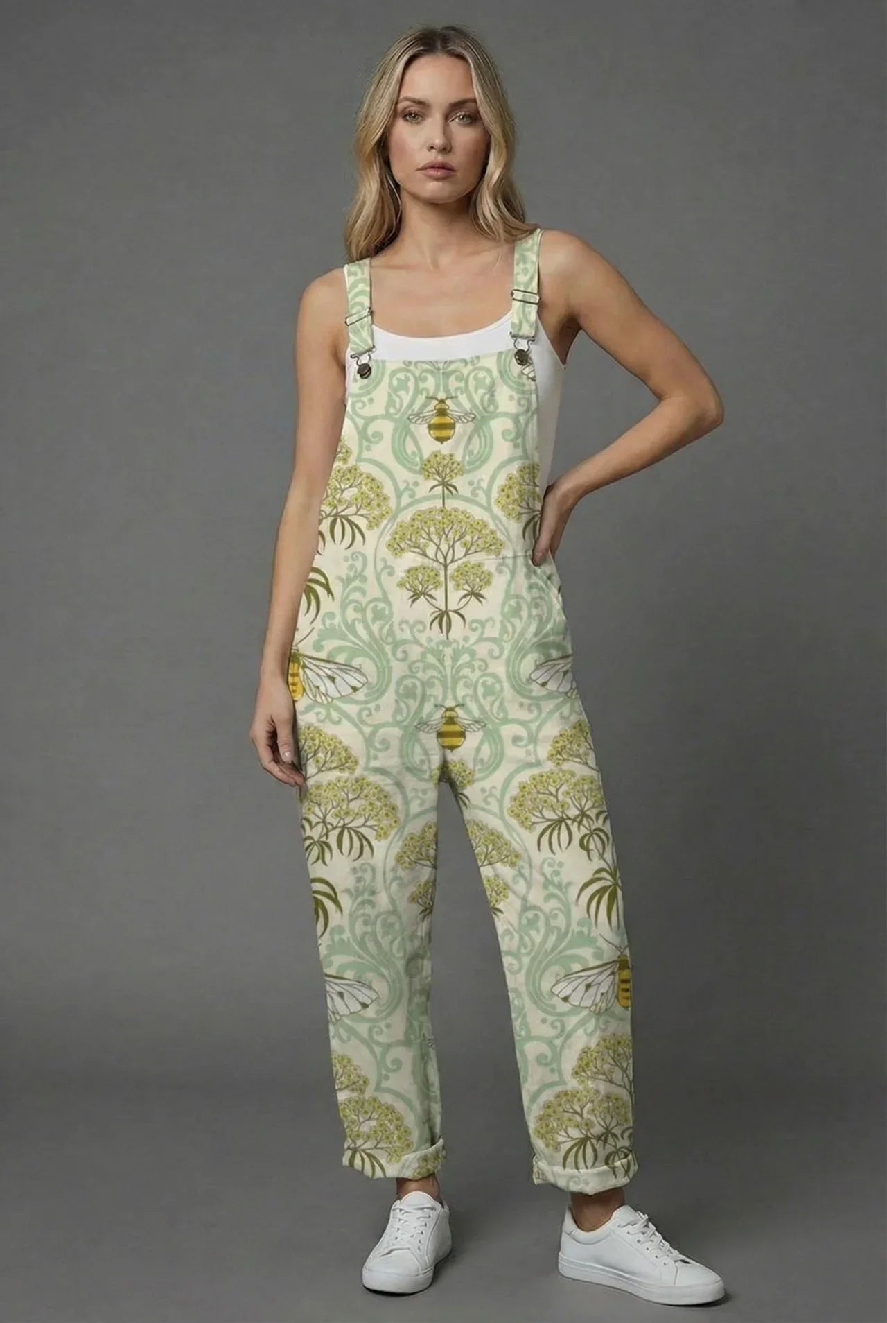 Side profile of botanical print women romper in sage green with straight-leg silhouette