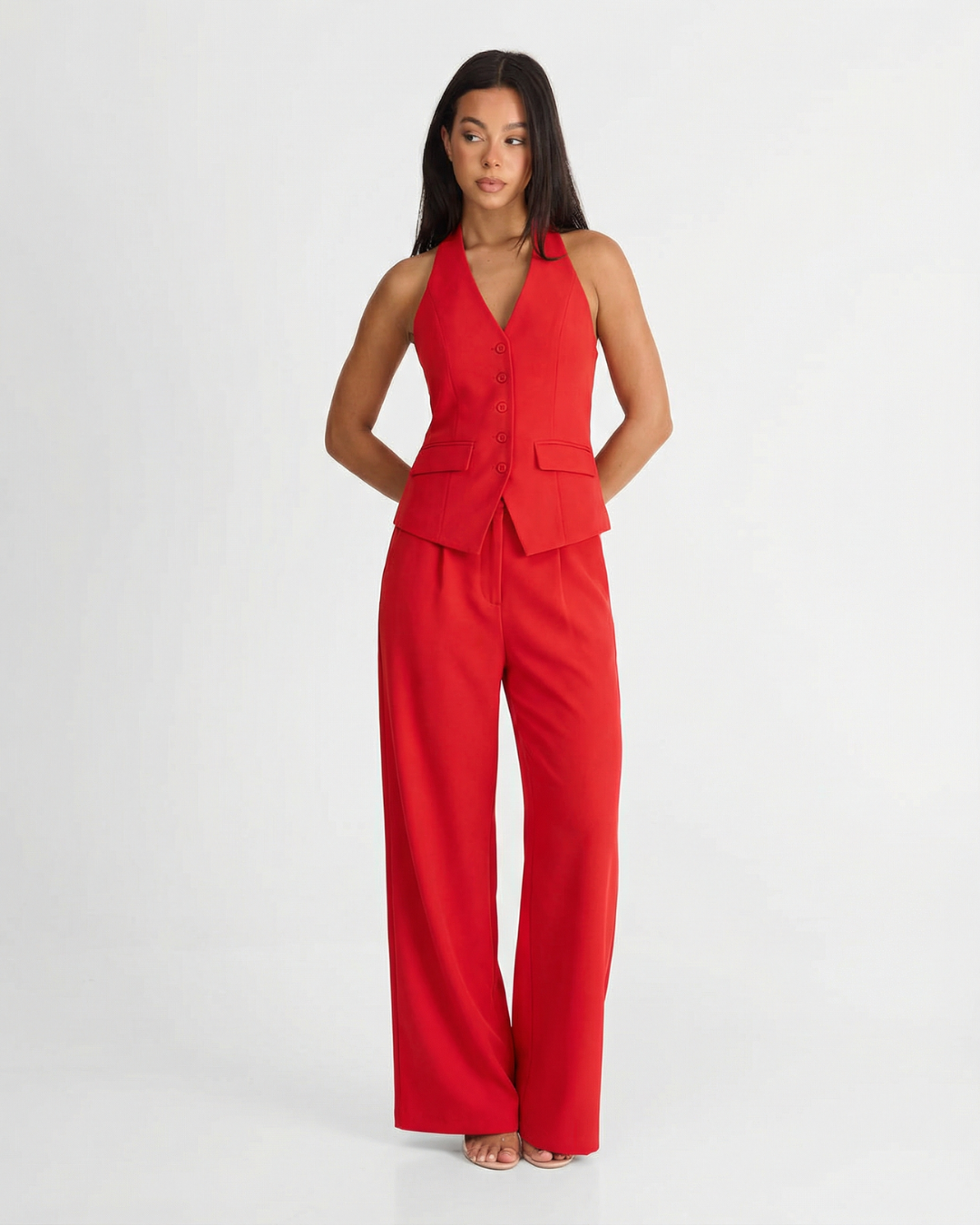Red halter wide leg pants set with tailored vest top and flowing trousers on model
