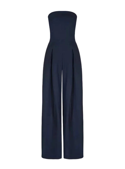 Front view of a navy strapless jumpsuit with pleated wide leg pants and clean neckline