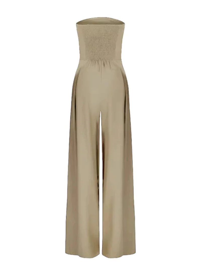 Beige strapless jumpsuit shown flat with smocked back and flowing wide leg pants