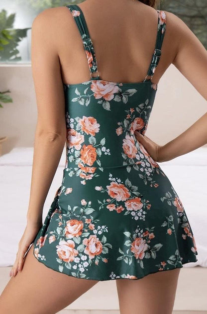 Back view of green floral swimsuit dress with adjustable straps and flared mini skirt