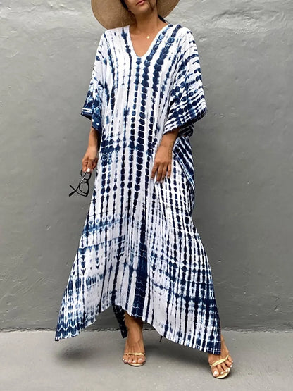 Blue and white tie dye maxi dress with V-neck, loose sleeves, and flowing hem