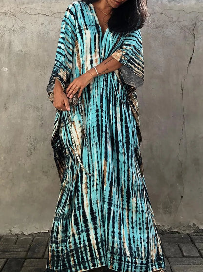 Turquoise tie dye maxi dress with V-neck, relaxed fit, and draped short sleeves