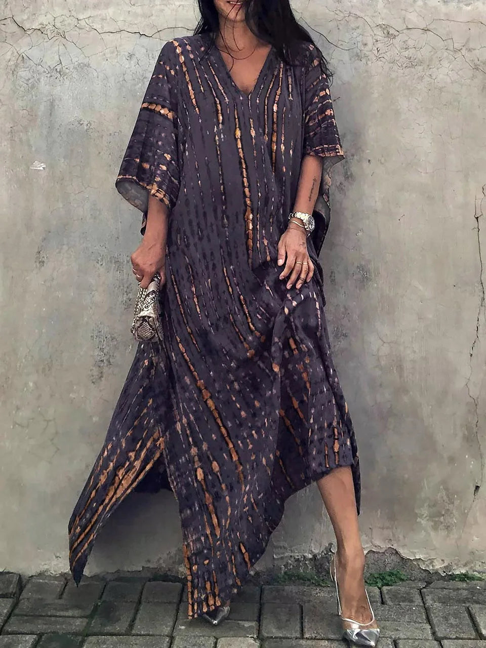Dark charcoal tie dye maxi dress with orange accents, V-neck, and asymmetrical hem