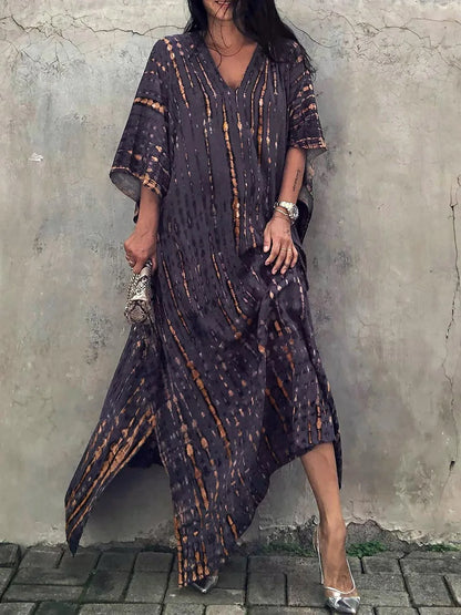 Dark charcoal tie dye maxi dress with orange accents, V-neck, and asymmetrical hem