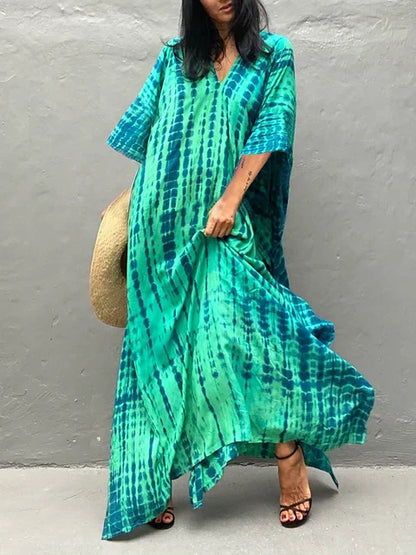 Teal and green tie dye maxi dress with loose sleeves and flowing summer dress silhouette