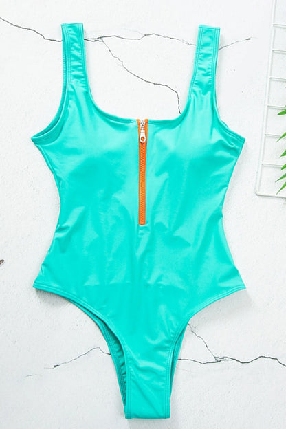 Turquoise one piece swimsuit with scoop neck and front zipper, flat lay view