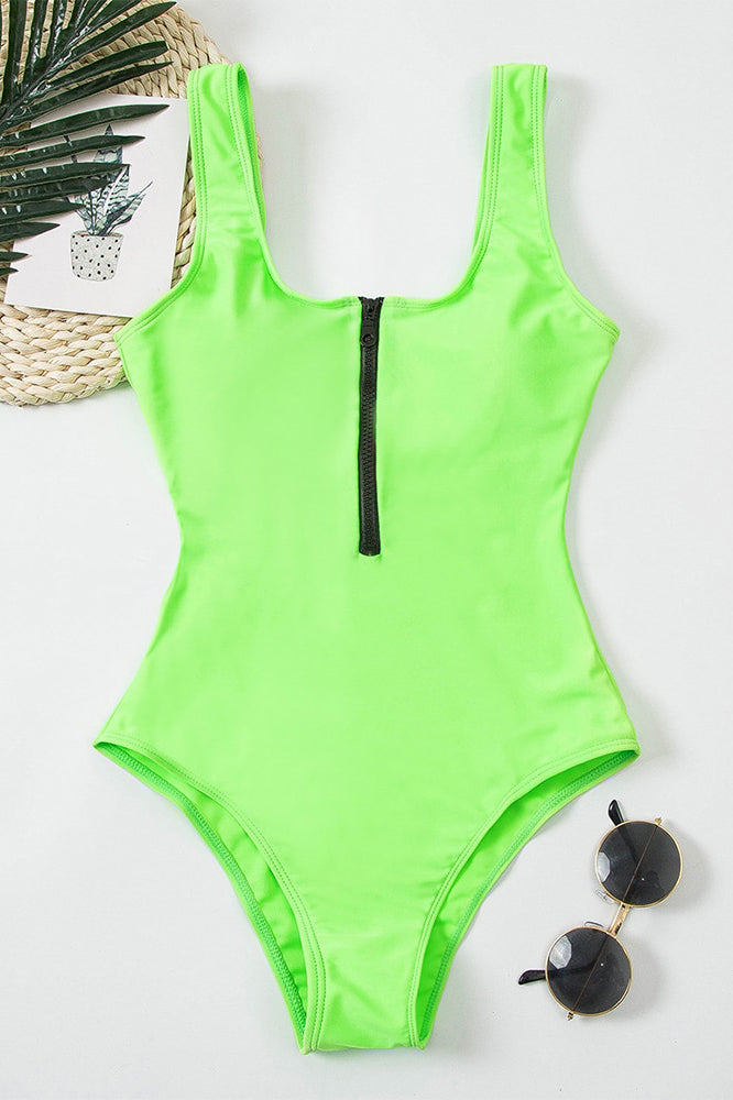Neon green one piece swimsuit with black front zipper and scoop neckline on model