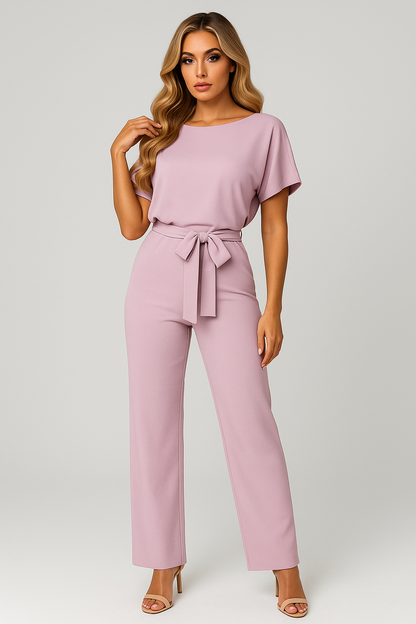 Pink wide leg jumpsuit with short sleeves, round neckline, and self-tie belt at the waist