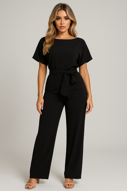 Black wide leg jumpsuit with short sleeves, belted waist, and relaxed straight silhouette