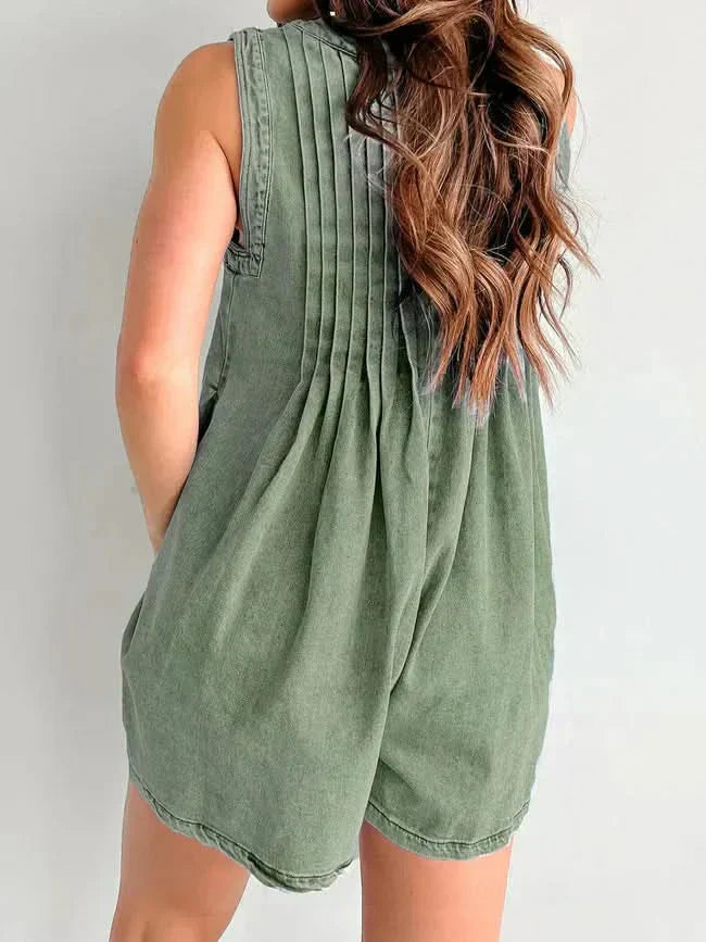 Back view of olive green mini denim romper with gathered pleats, sleeveless design, and loose shorts
