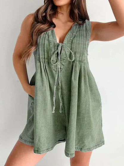 Olive green women's mini denim romper with V-neck tie front, pleated top, and relaxed shorts fit