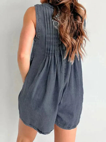 Back view of dark denim romper for women with gathered back pleats and sleeveless mini shorts
