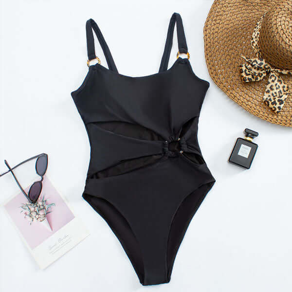 Black one piece swimsuit with side cutouts, ring accent, and adjustable straps