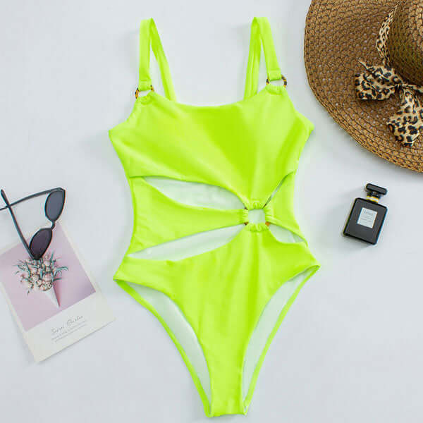 Neon green cut out one piece swimsuit laid flat with side ring detail and high leg