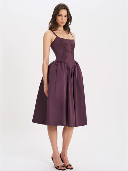 Front view of plum cocktail midi dress with floral embroidery and voluminous skirt
