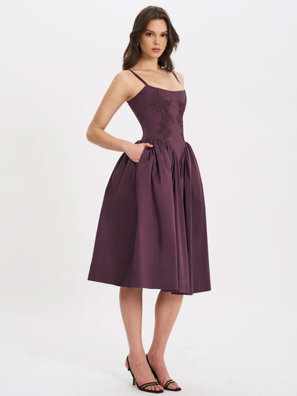 Back view of plum embroidered midi dress with spaghetti straps and full skirt
