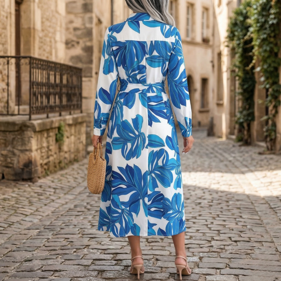 Back view of blue floral maxi shirt dress with long sleeves and midi-length hem