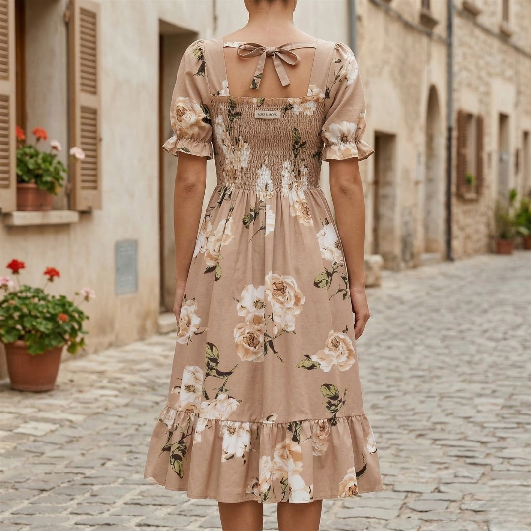 Back view of beige floral midi dress with square back, tie detail, and ruffled hem