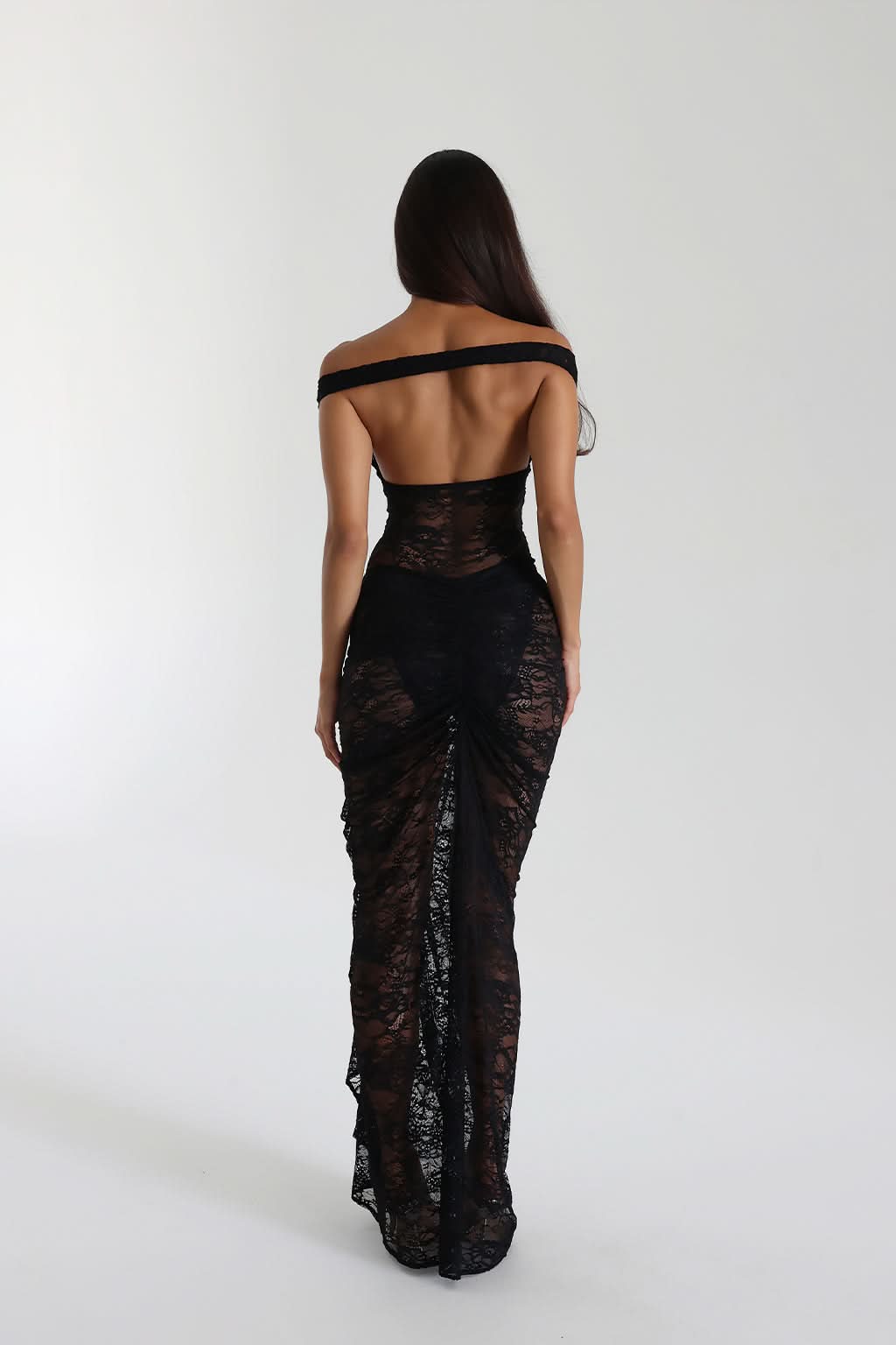 Back view of black off shoulder lace maxi dress with open back and floor length hem