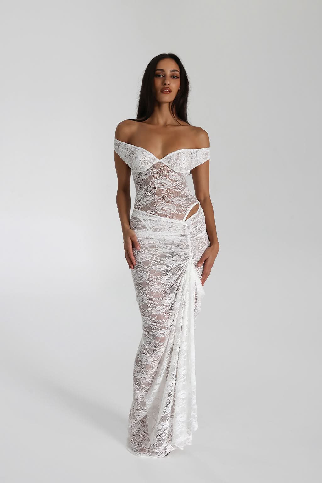 Back view of white off shoulder lace maxi dress with sheer lace fabric and draped skirt