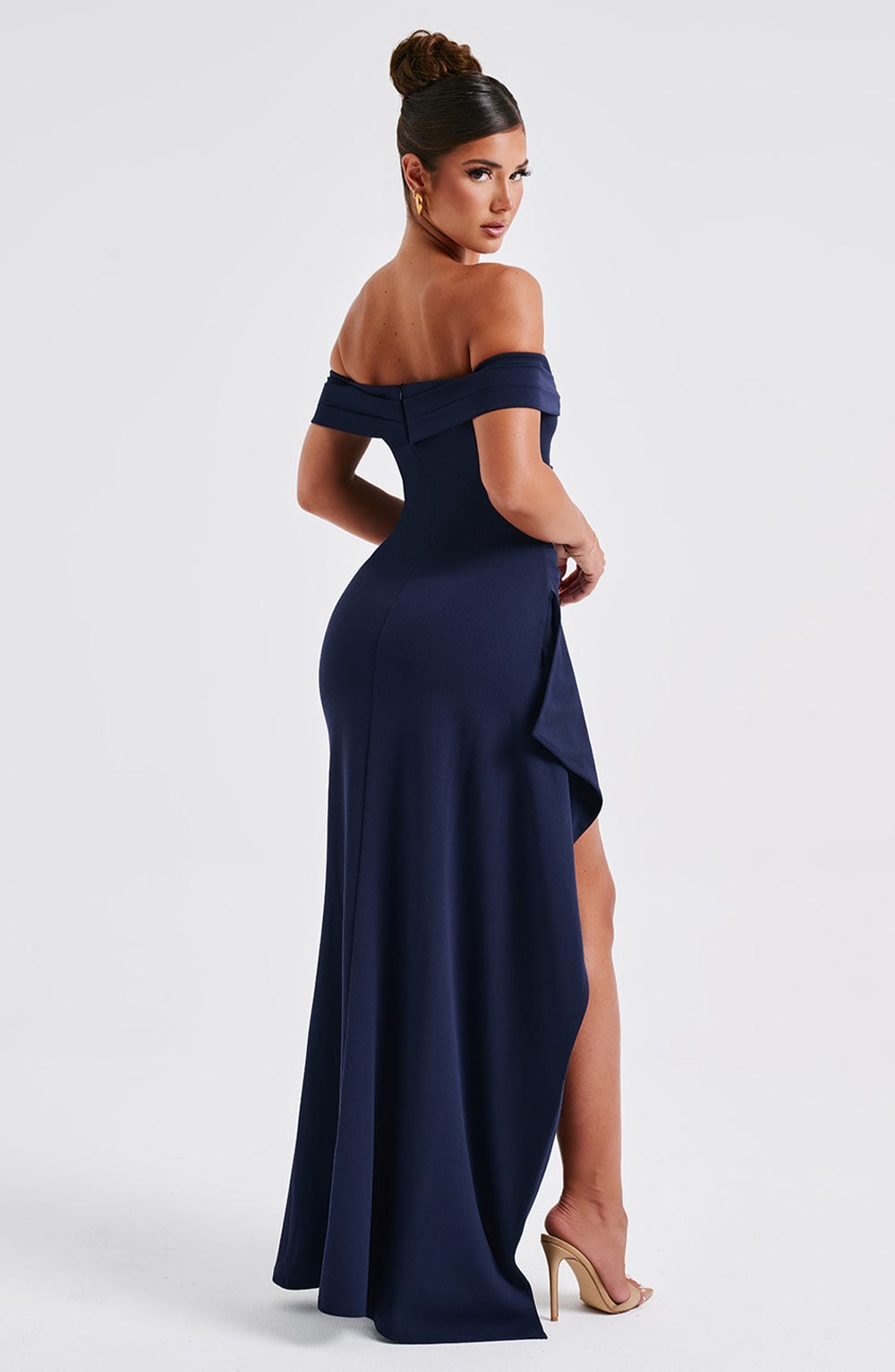 Side back view of navy formal maxi dress showing draped skirt and slit detail