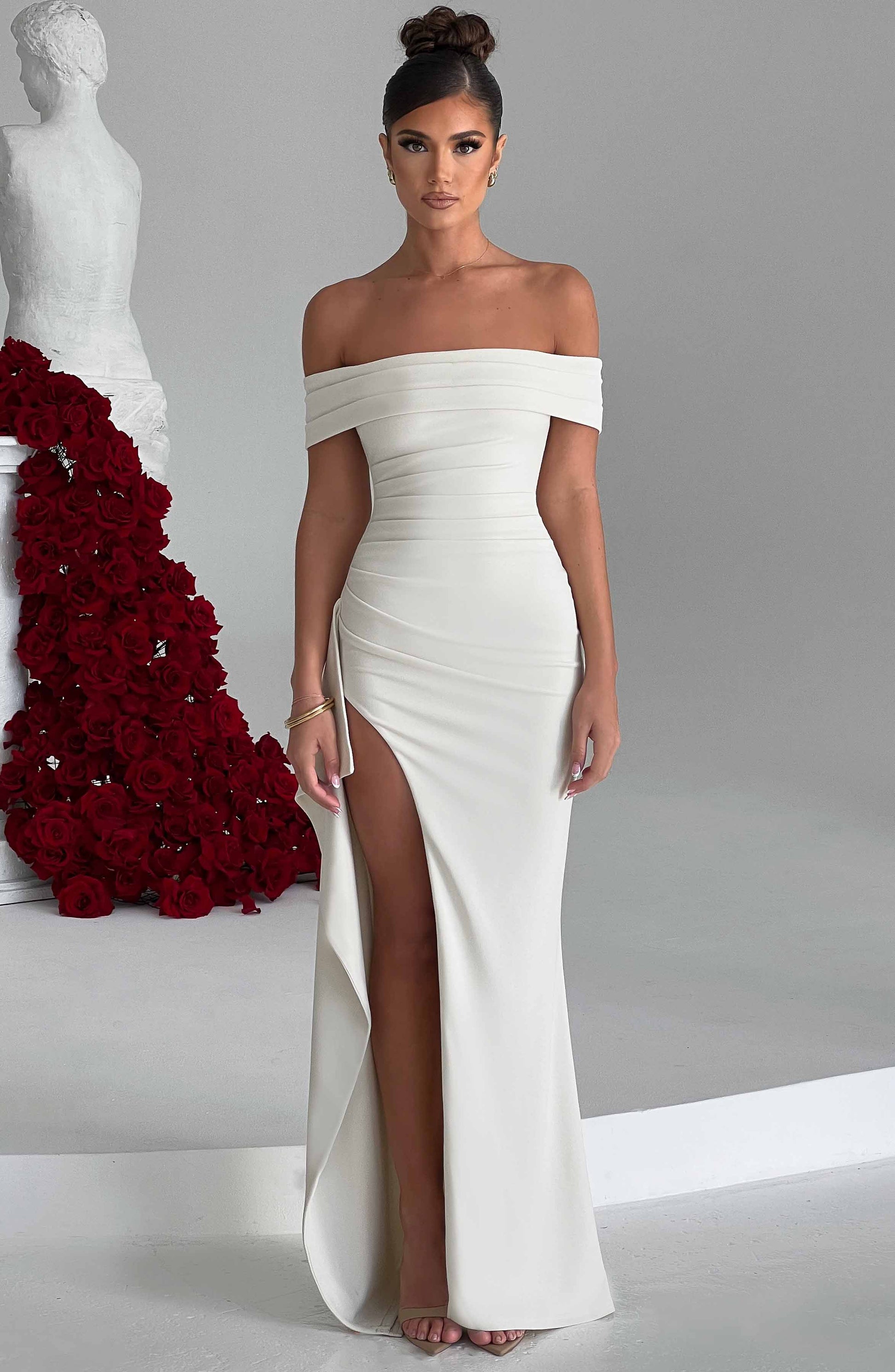 White off shoulder maxi dress with ruched bodice and dramatic thigh slit, front view