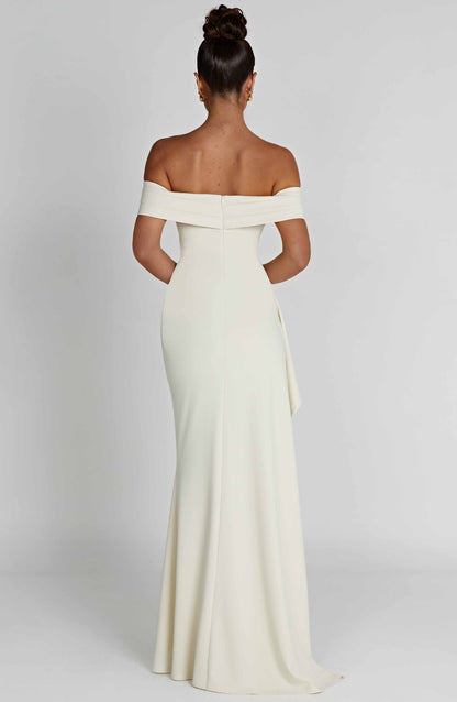 Back view of ivory off shoulder maxi dress with fitted bodice and floor length skirt