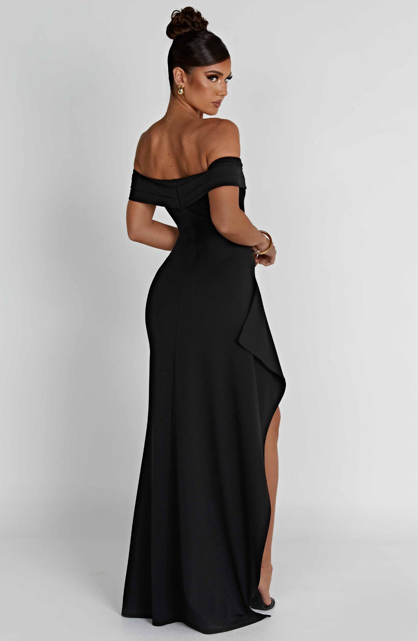Back view of black off shoulder maxi dress with zip closure and smooth floor length skirt