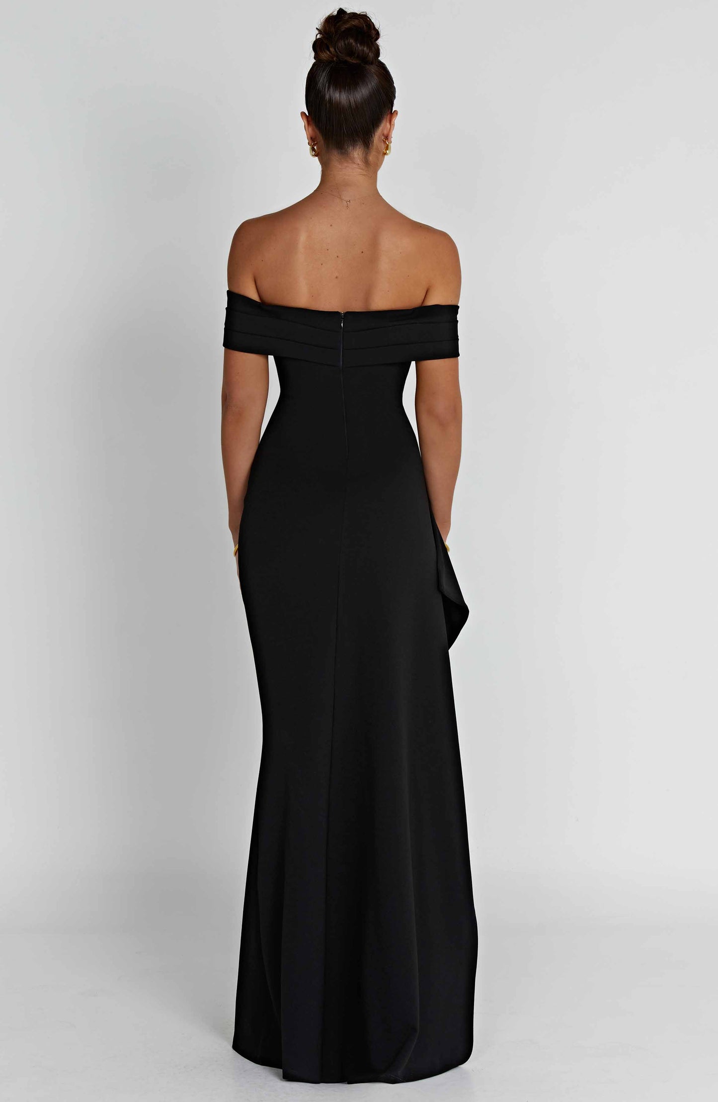 Black off shoulder maxi dress with fitted bodice, asymmetric drape, and formal thigh slit