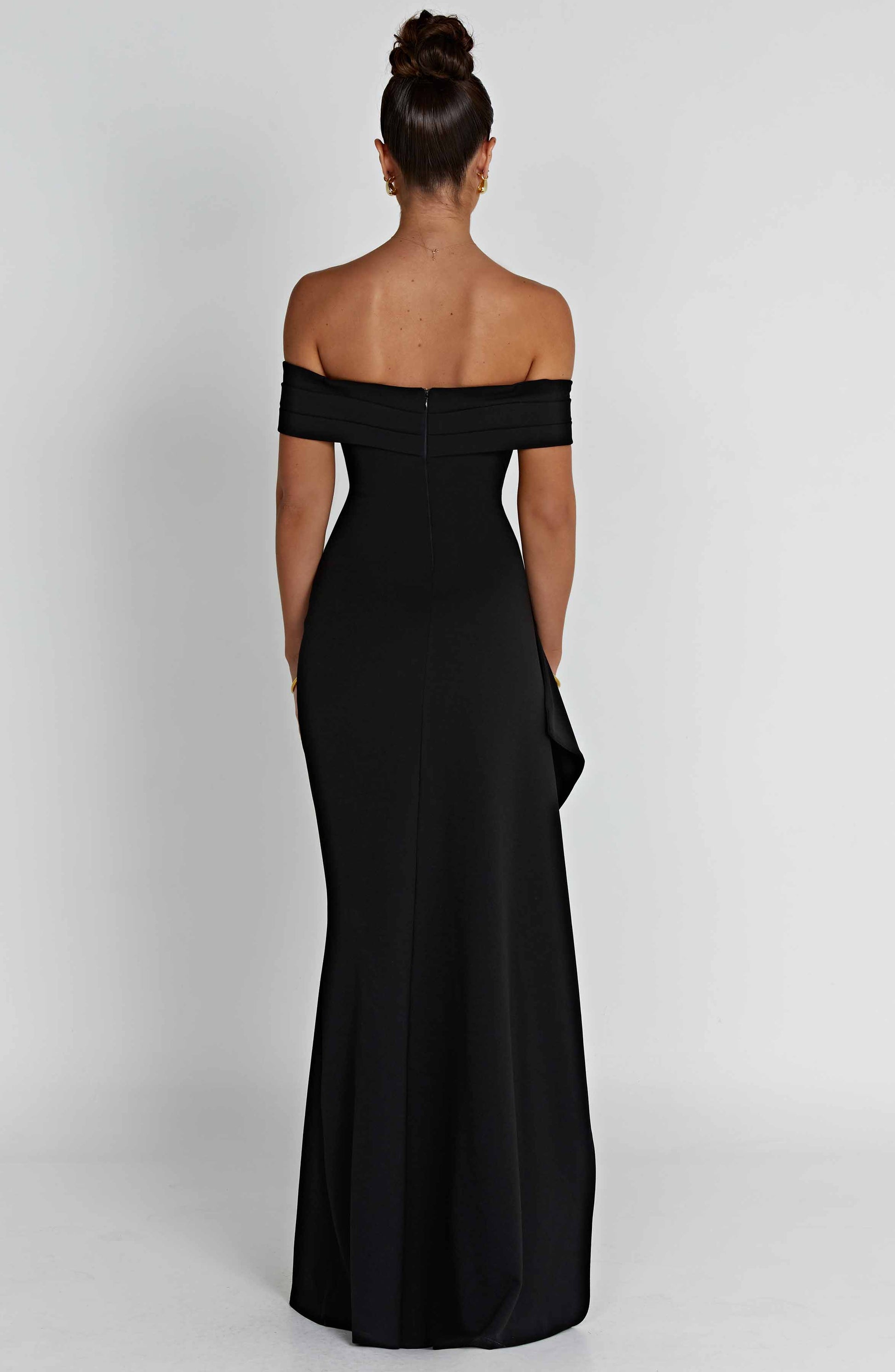 Black off shoulder maxi dress with fitted bodice, asymmetric drape, and formal thigh slit