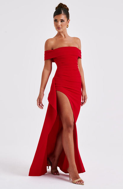 Back view of red off shoulder maxi dress with open neckline, fitted back, and long train