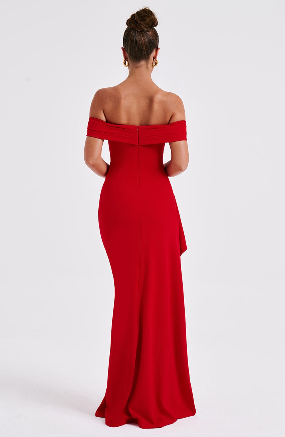 Back view of red off shoulder maxi dress with fitted silhouette and floor length hem