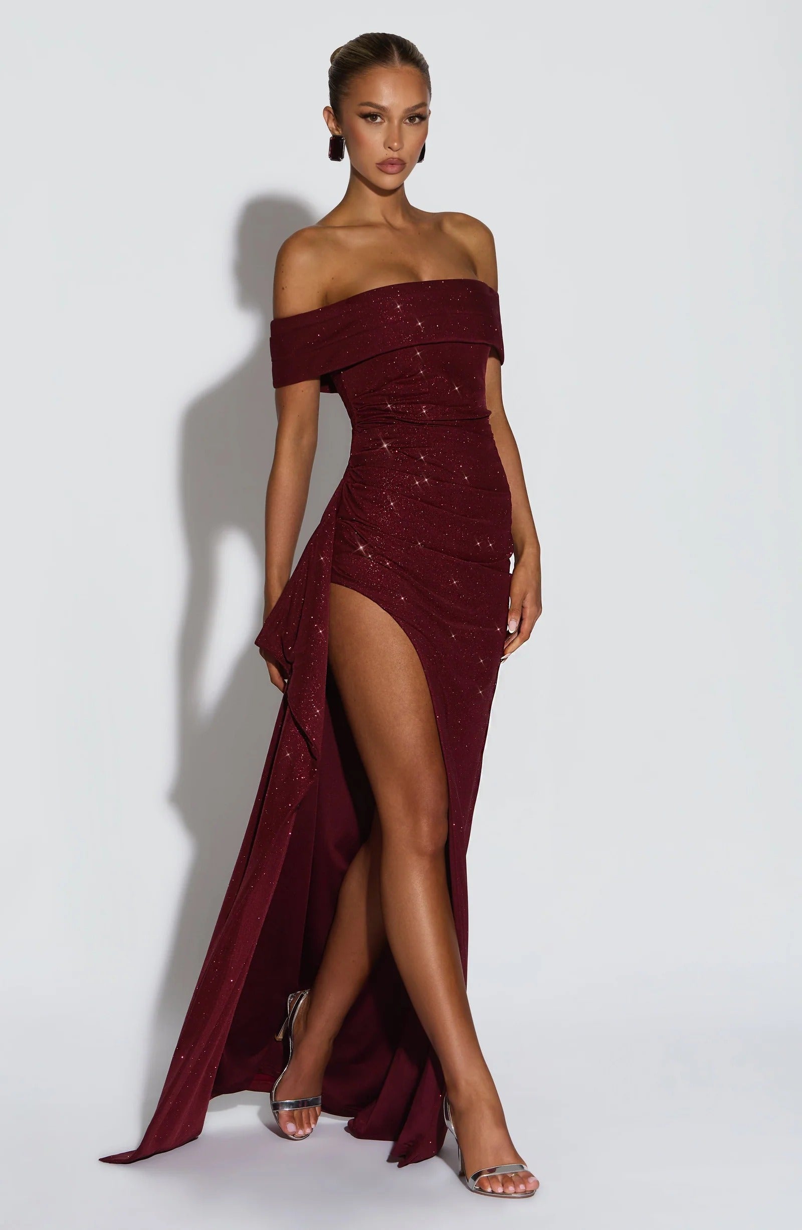 Back view of burgundy formal maxi dress with off shoulder neckline and floor length hem