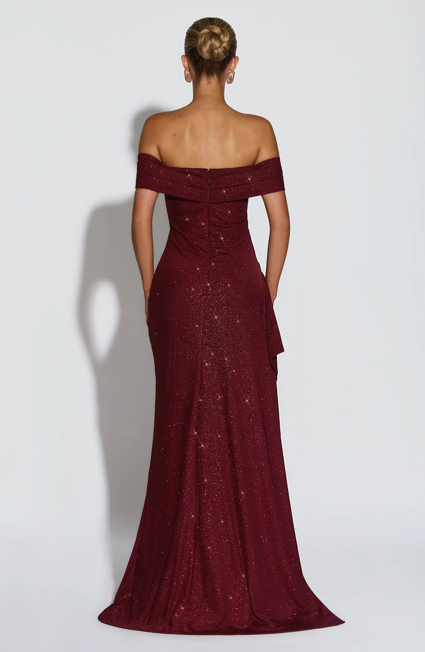 Close front view of burgundy off shoulder maxi dress with ruched bodice and side slit