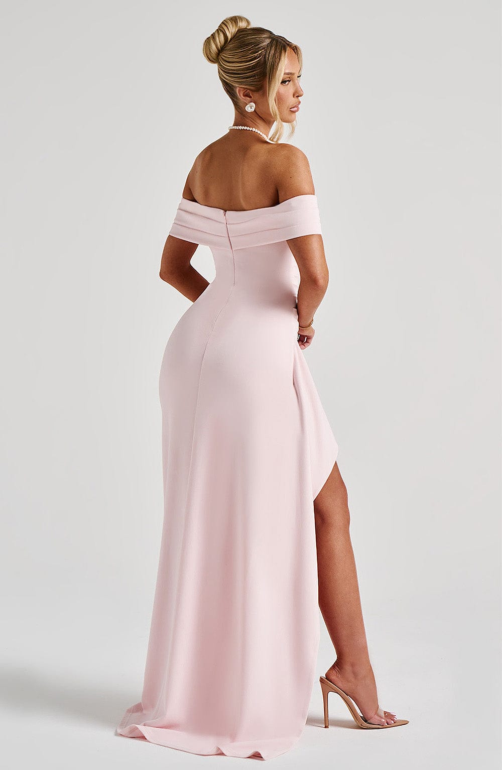 Back view of light pink off shoulder maxi dress with zipper closure and floor-length hem