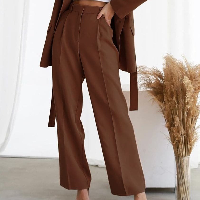 Brown high waisted wide leg linen pants with pleats and a relaxed straight fit